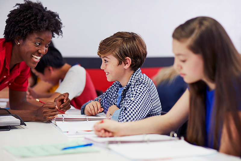 Mathnasium tutor explains a math concept to an engaged student.