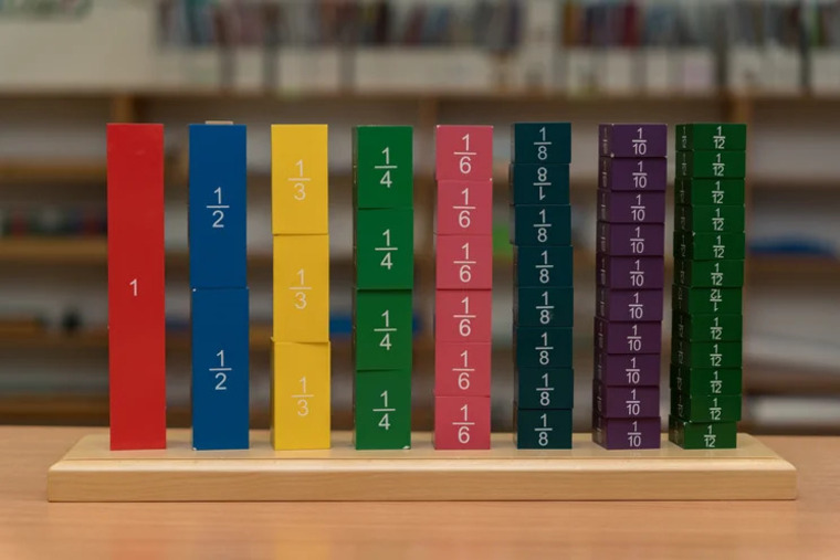 A wooden block surrounded by various colored blocks, showcasing a playful arrangement of shapes and hues.