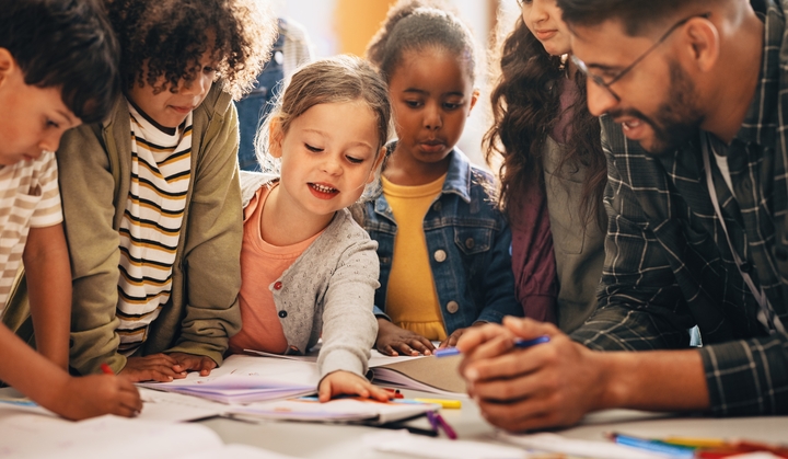 Diverse group of children at a table.
