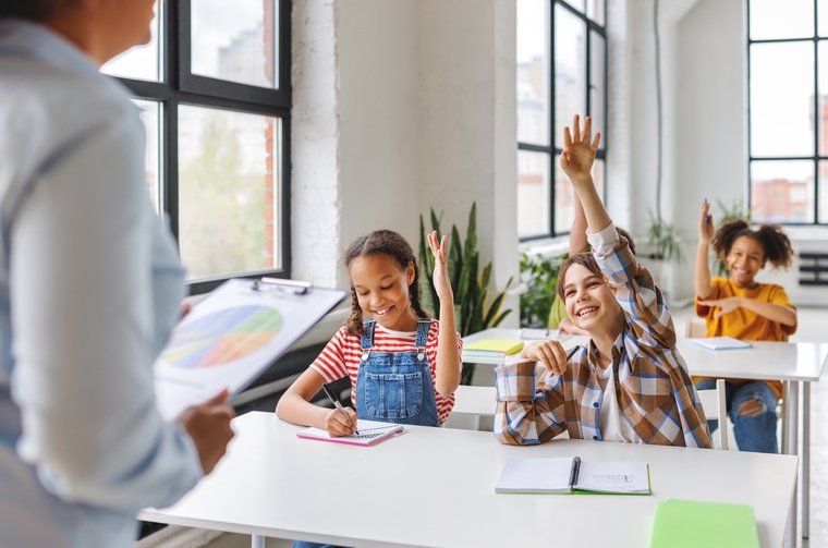 school kids enthusiastically participating in math class