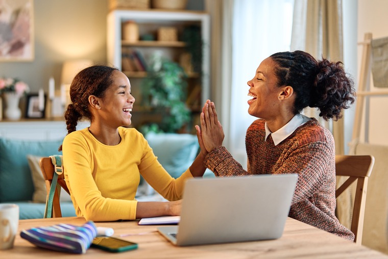 A female student and her parent applying for a scholarship program online