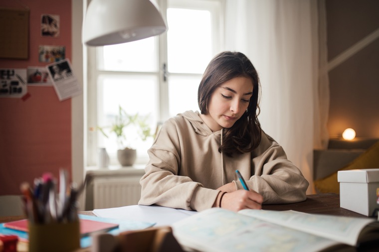 Girl doing math homework, preparing for cumulative math final