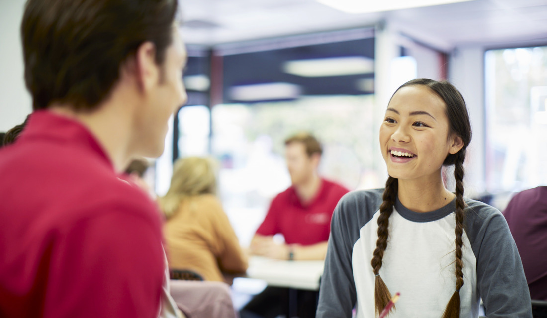 Instructor and Asian student laughing