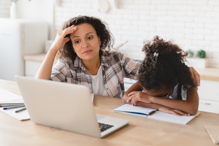 Stressed mom and child struggling with math homework at home