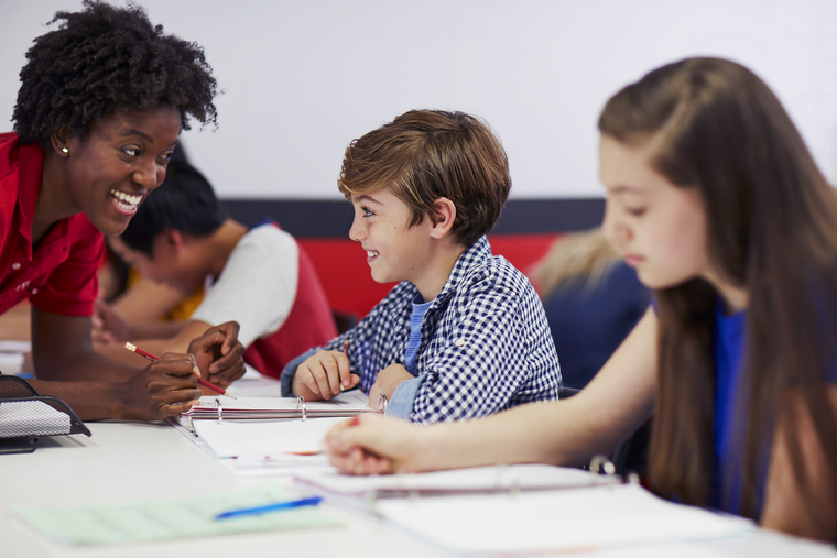 Mathnasium tutor engaging with elementary students during a face-to-face group session