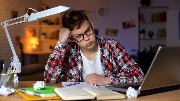 Anxious math student struggling to solve a challenging math algebra 2 problem, resting head on hand with a worried expression