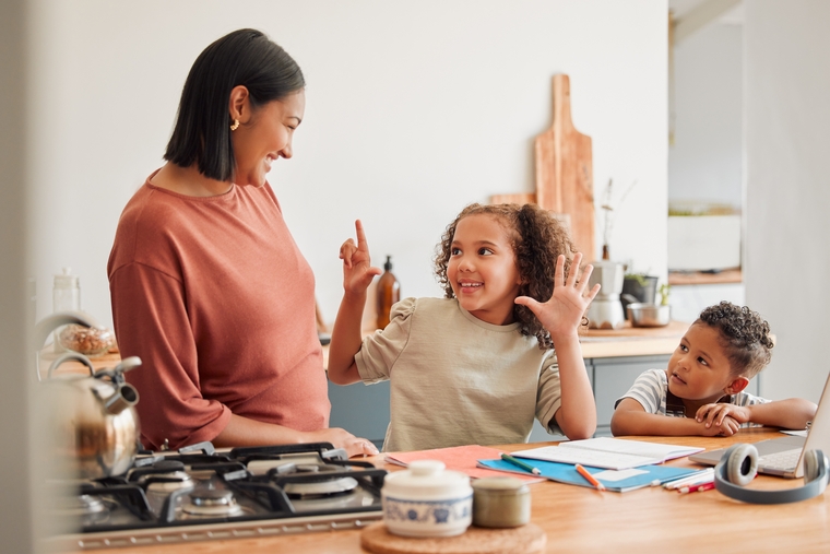 Child using hand gestures to explain a math concept at home, showing engagement through storytelling