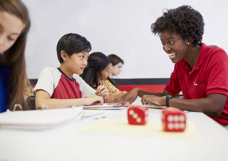 Mathnasium instructor working with students in a small group setting, promoting collaboration and peer learning in math