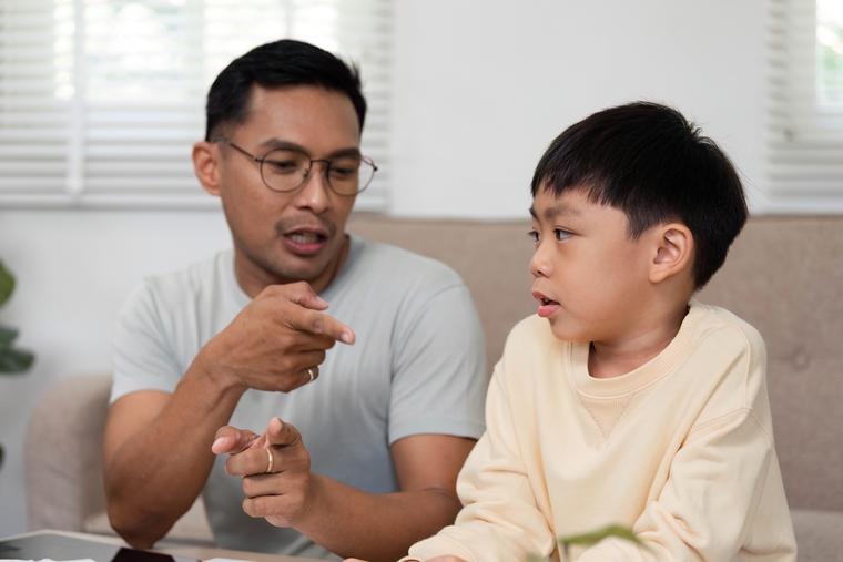 A parent guides his child through a “Would You Rather?” question