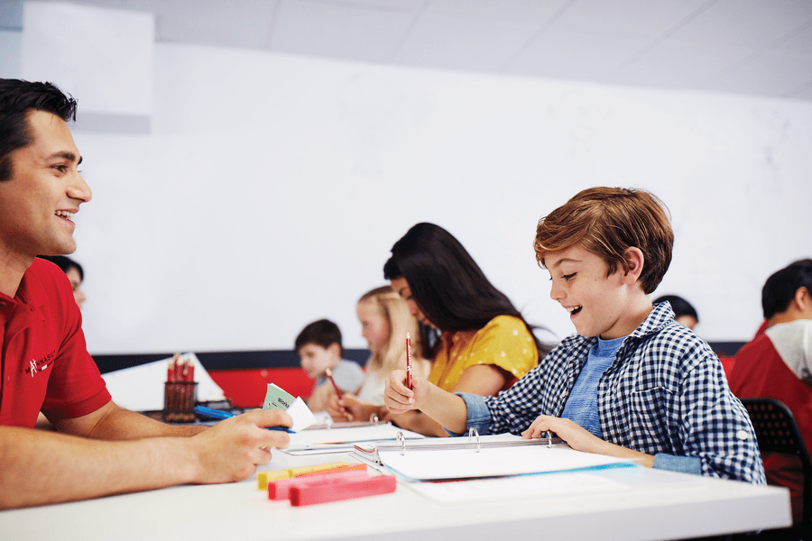 A Mathnasium tutor helping a young boy with math