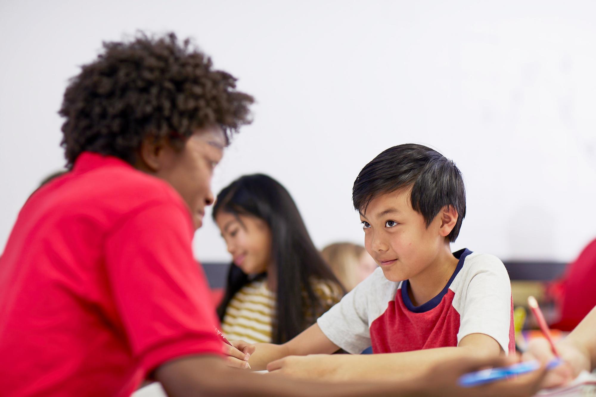 Mathnasium tutor explains math concepts to a student.