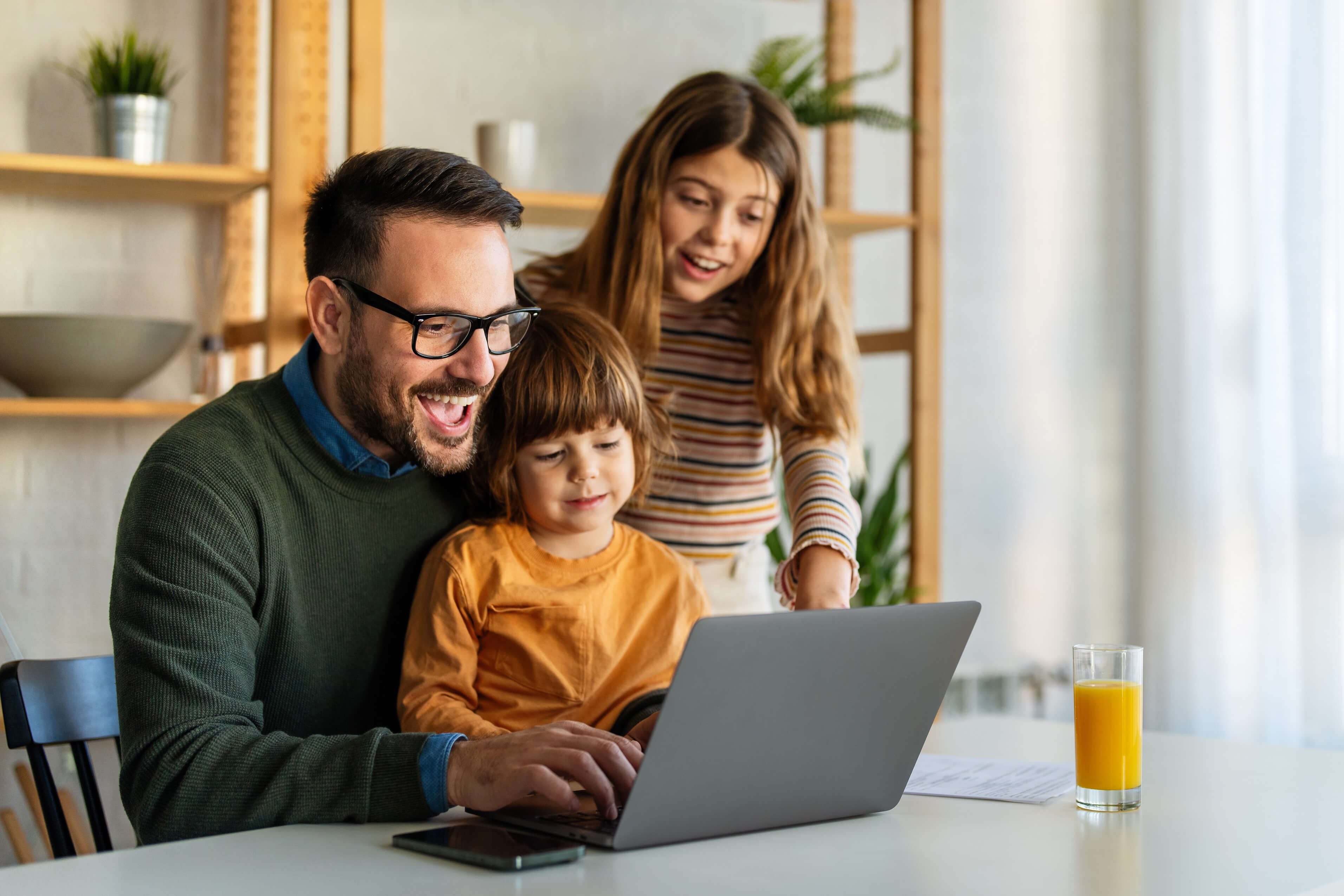 Parent and children next to a computer