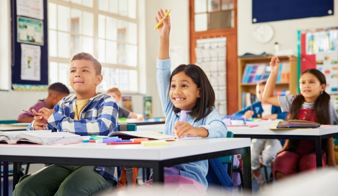Students sitting in a classroom, with one boy looking uncertain, reflecting the fear of making mistakes in math.