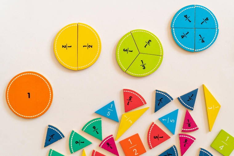 Colorful circular fraction tiles showing fractional parts like 1/2, 1/3, 1/4, and 1/8.
