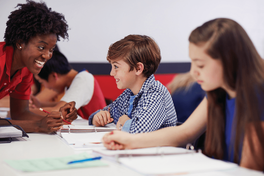 Mathnasium tutor helping a young students with a math problem
