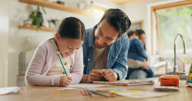 Father and daughter in the kitchen, writing SMART math goals for next school year