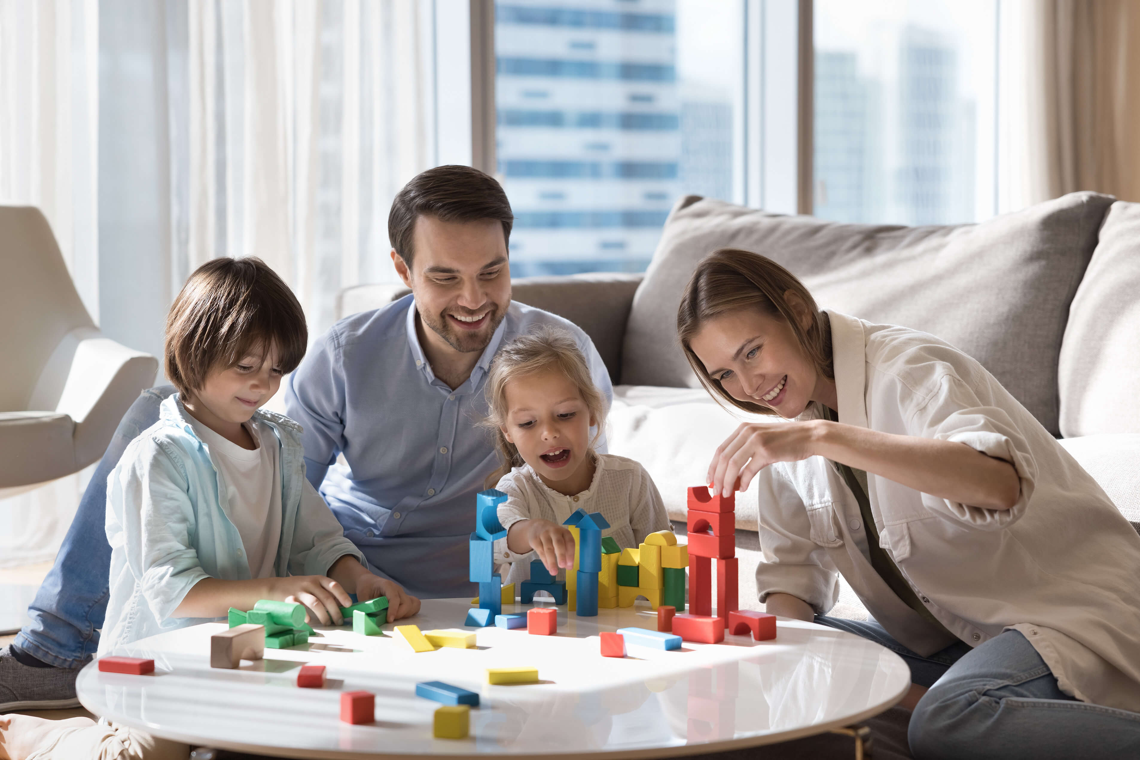A family playing with colorful building blocks