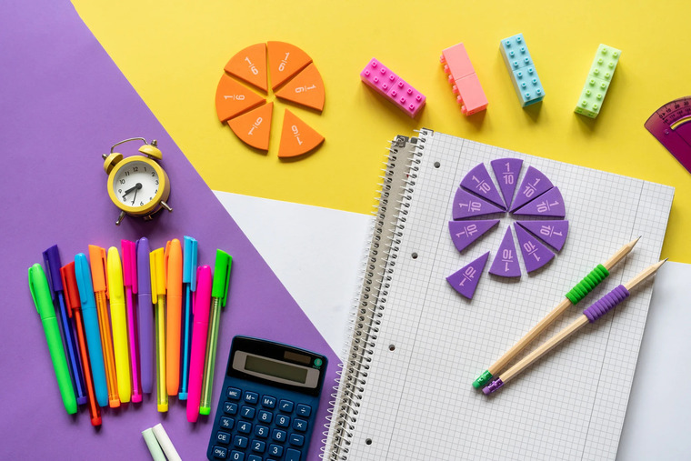 Brightly colored stationery and pens on a lively background, illustrating the tools that support STEM professionals in their work.