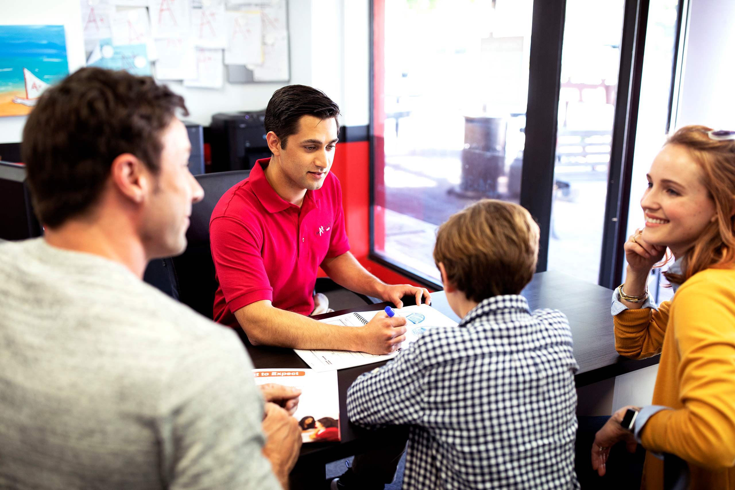 Mathnasium tutor goes through a personalized plan with student and parents.