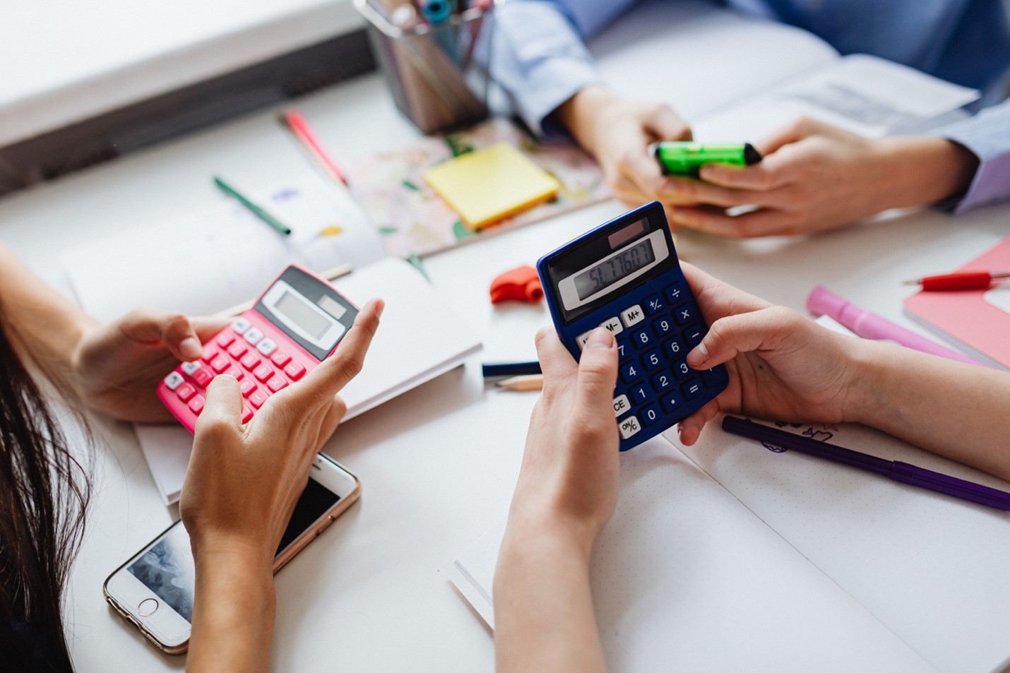 Group-of-people-using-calculators-at-a-desk.jpg