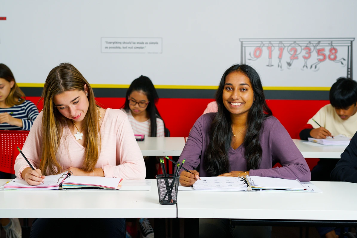 Teenage girl with long hair smiling in her trigonometry tutoring class