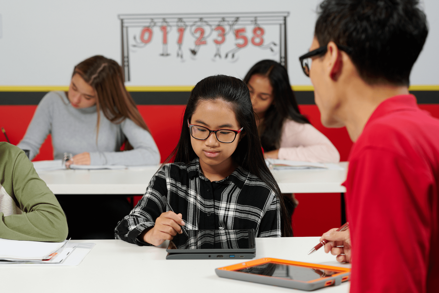 Student and math tutor solving equations at a math learning center