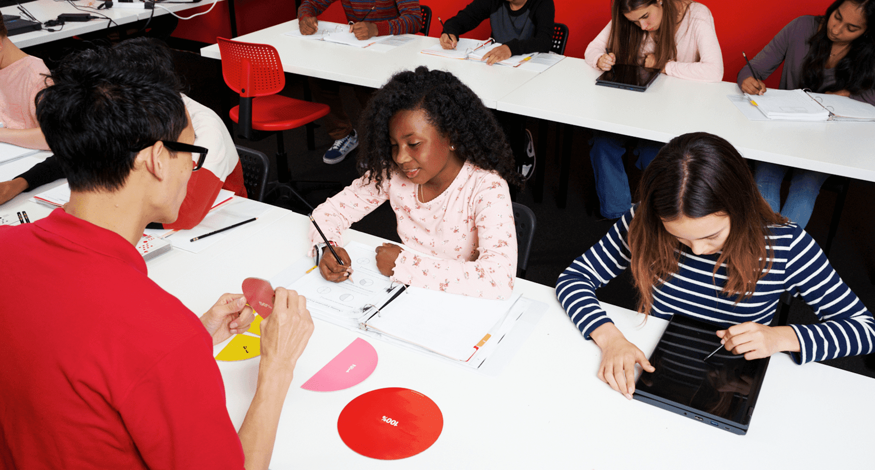 Students using math workbooks during a focused classroom lesson