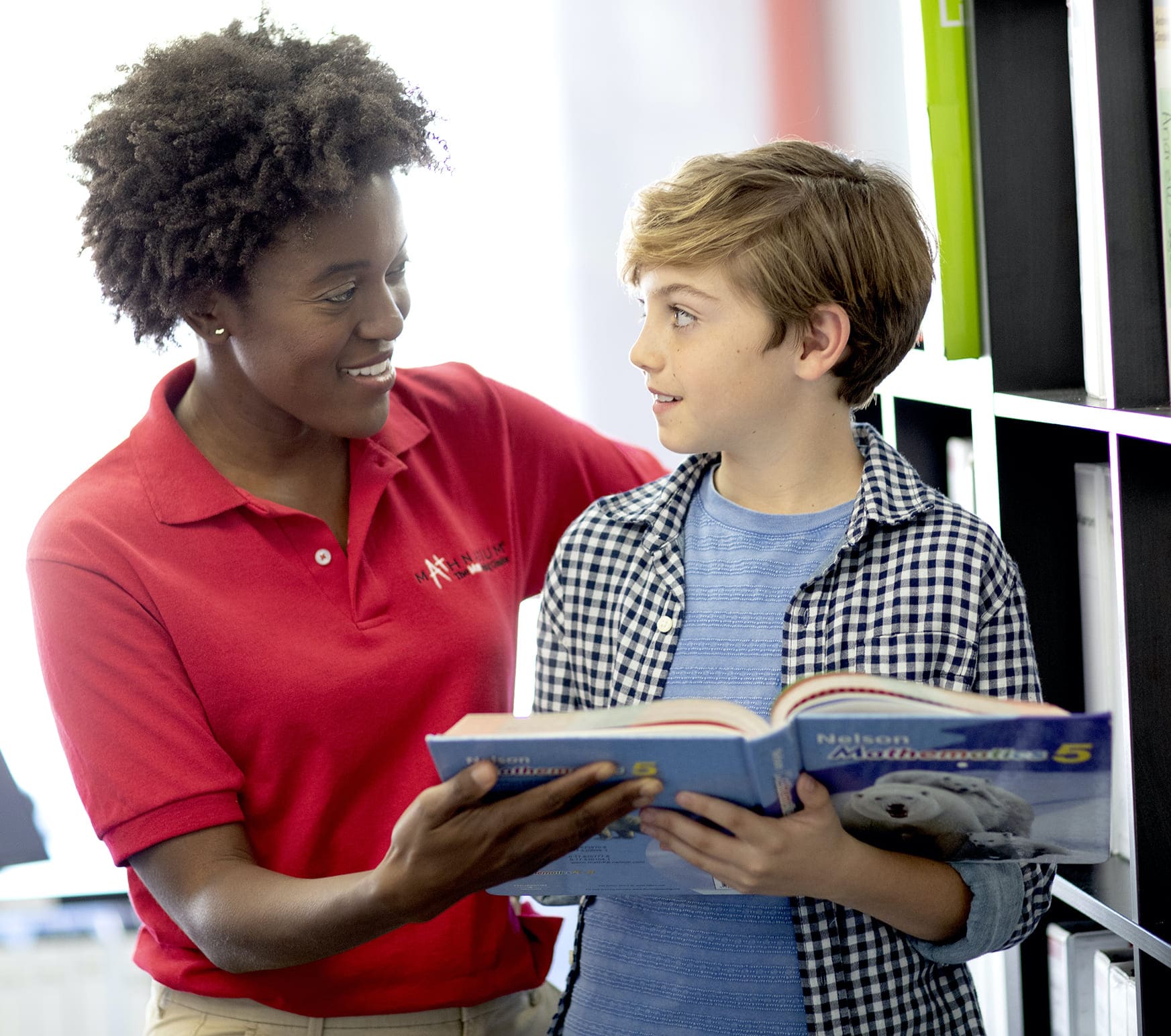 A specially trained and caring math tutor teaching math to a student.