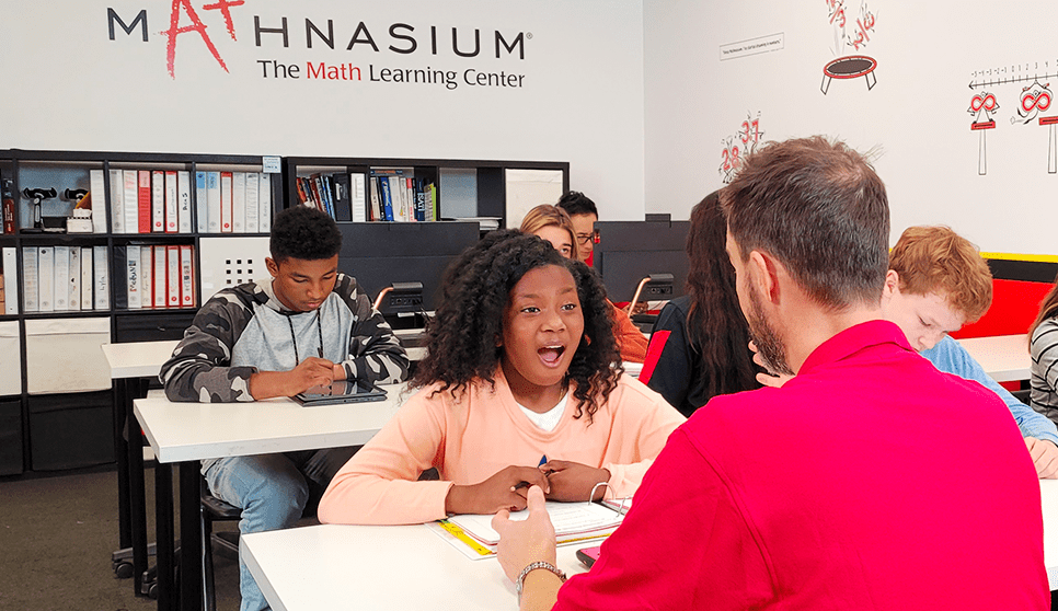 Math tutor encouraging student during problem-solving session