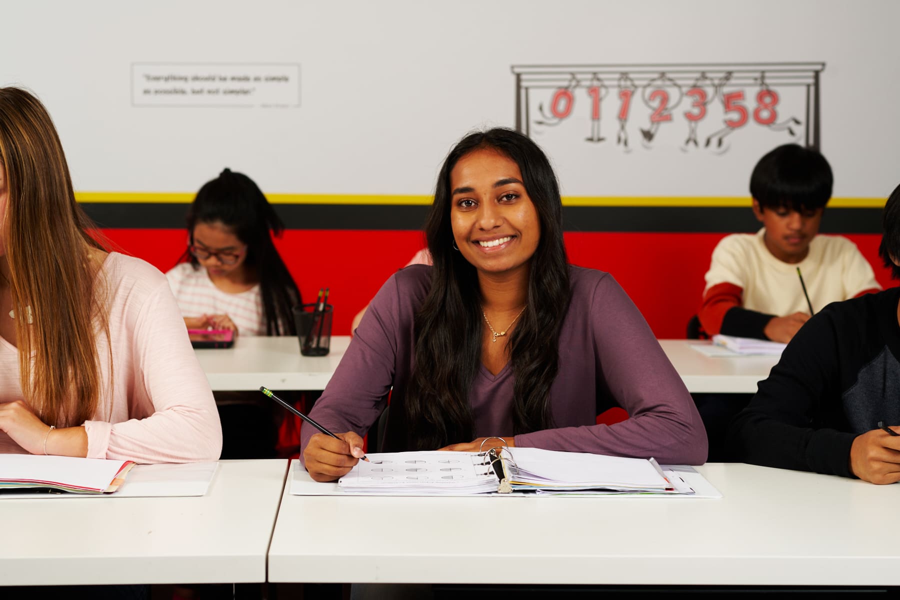 A happy high school student during a math tutoring session