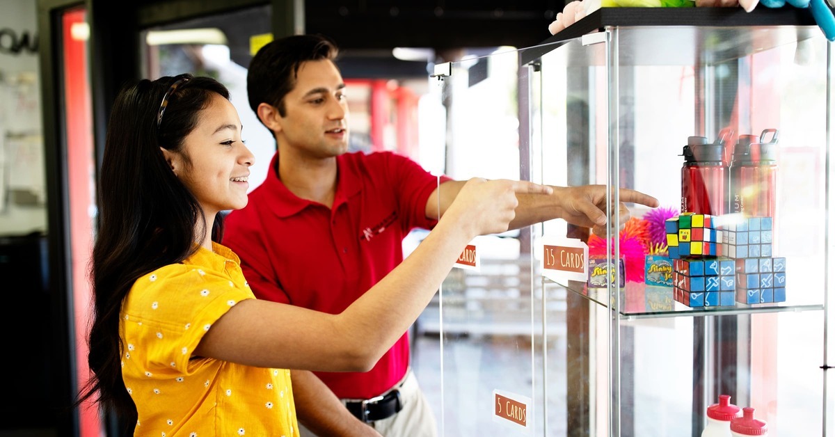 Student and math tutor choosing math learning aids