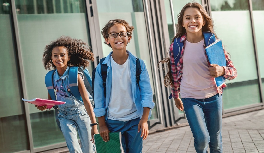 a group of middle school students and My Spark scholarship recipients running joyfully after class