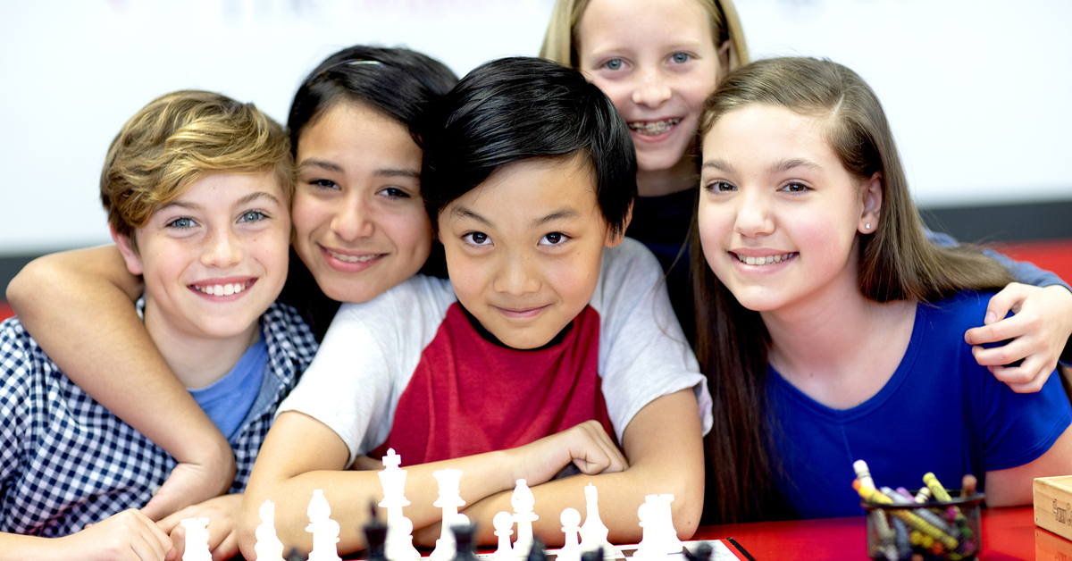 A group of students next to a chess board