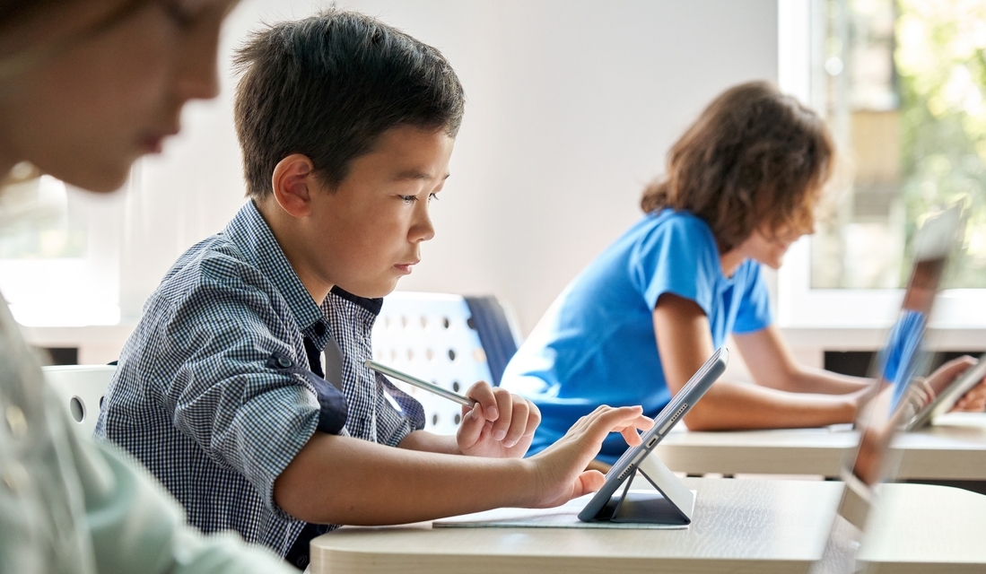 Focused student using a tablet during math class