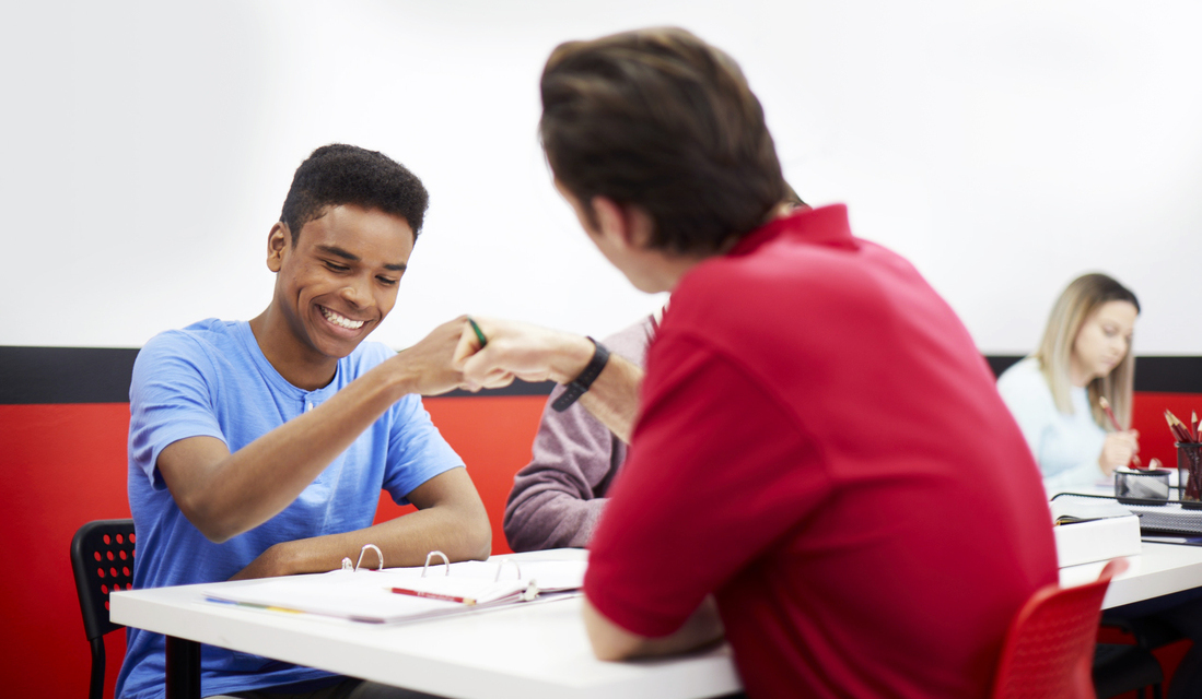 Tutor and student high-fiving during math tutoring session