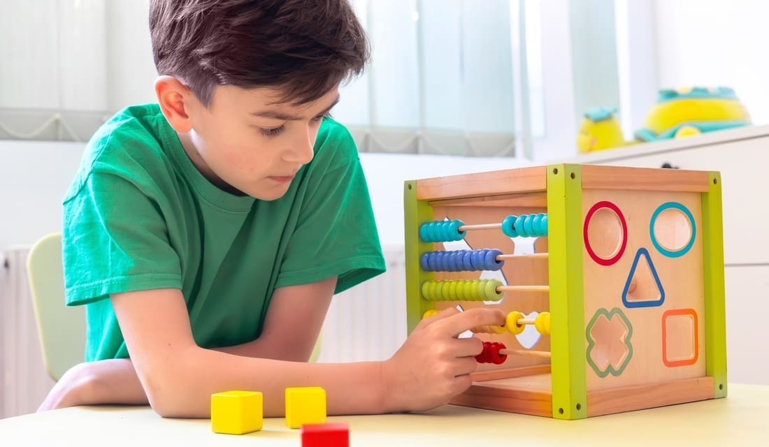 A young elementary student engaging in a hands-on math activity