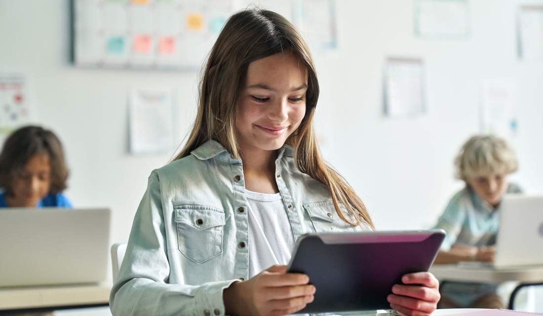 A female middle-school student smiling after seeing math test results