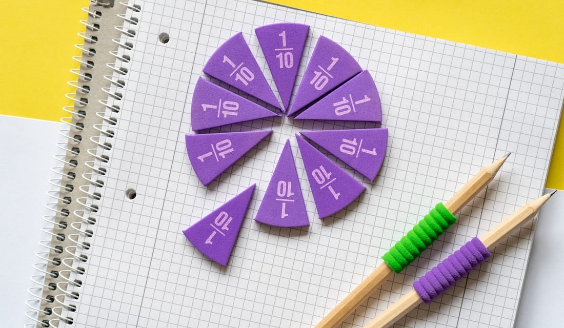 A purple and green pencil rests beside a spiral-shaped piece of paper, showcasing a creative workspace.