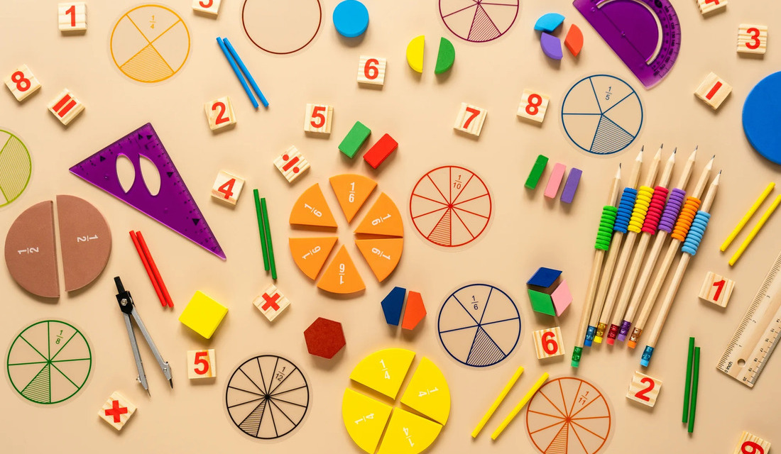 A colorful collection of school supplies, such as pencils, erasers, and folders, displayed on a wooden table.