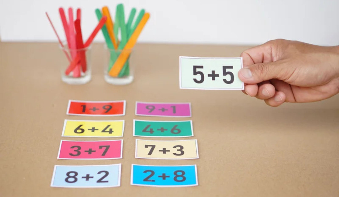 Individual presenting a sheet of paper with a prominent number, indicating important information.