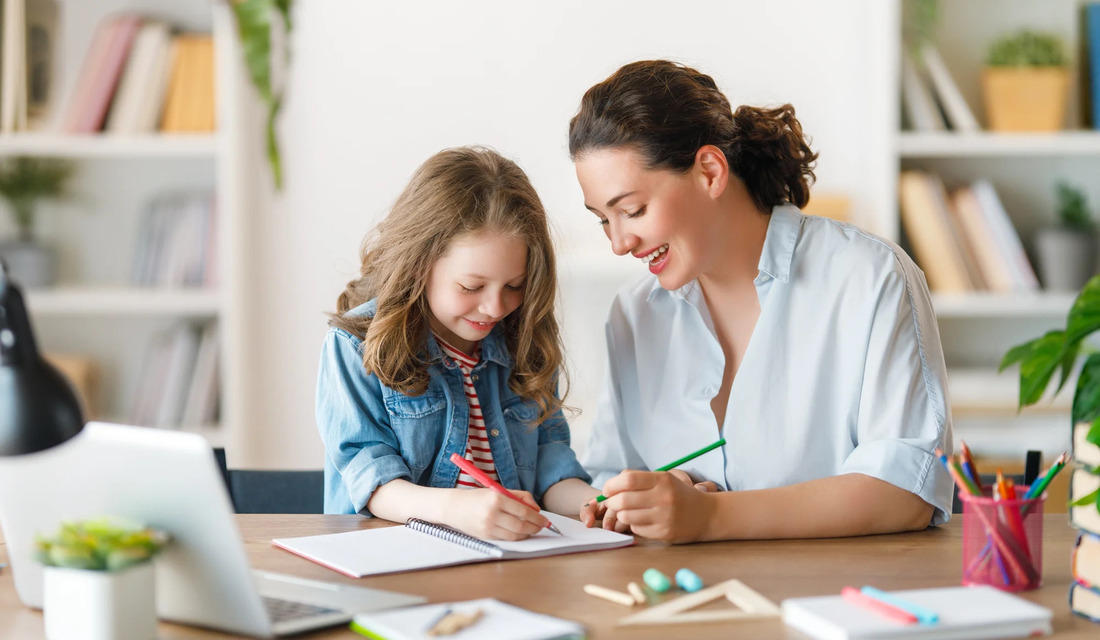 Mother or teacher helping a child