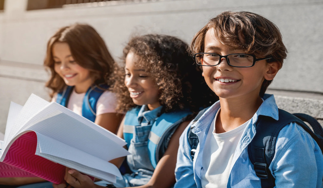Group of kids outside reading