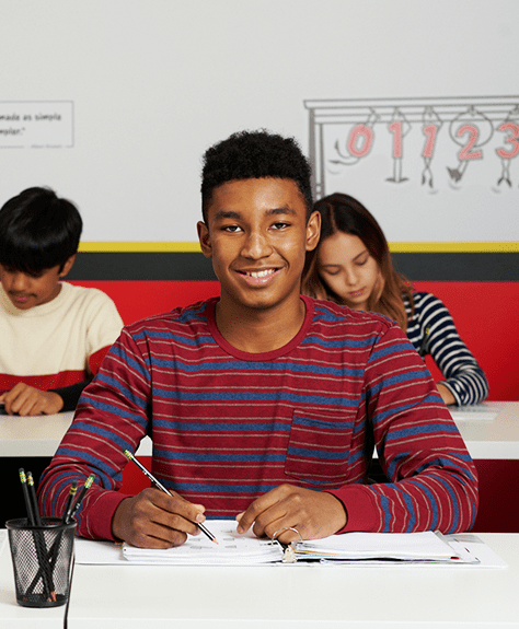 teenage boy smiling in an algebra 2 tutoring class