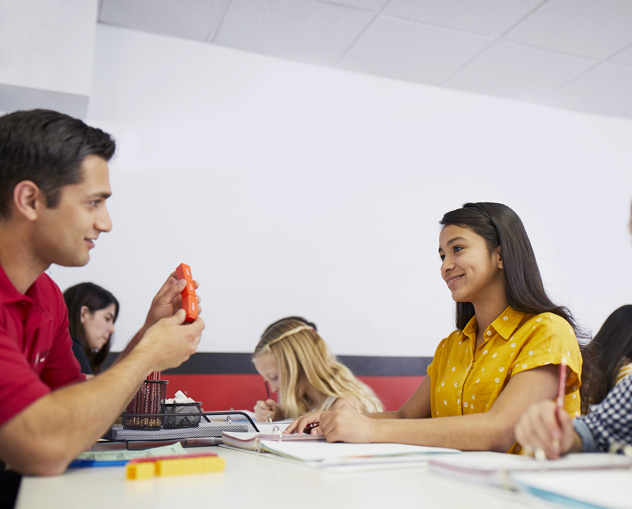 Mathnasium tutor explaining math concepts to a young student