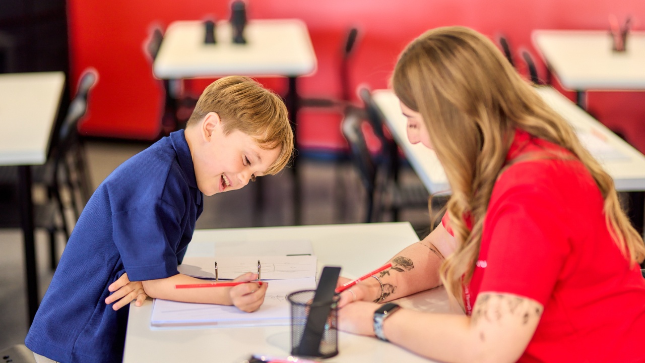 Child working on maths with an instructor at a Mathnasium Learning Centre